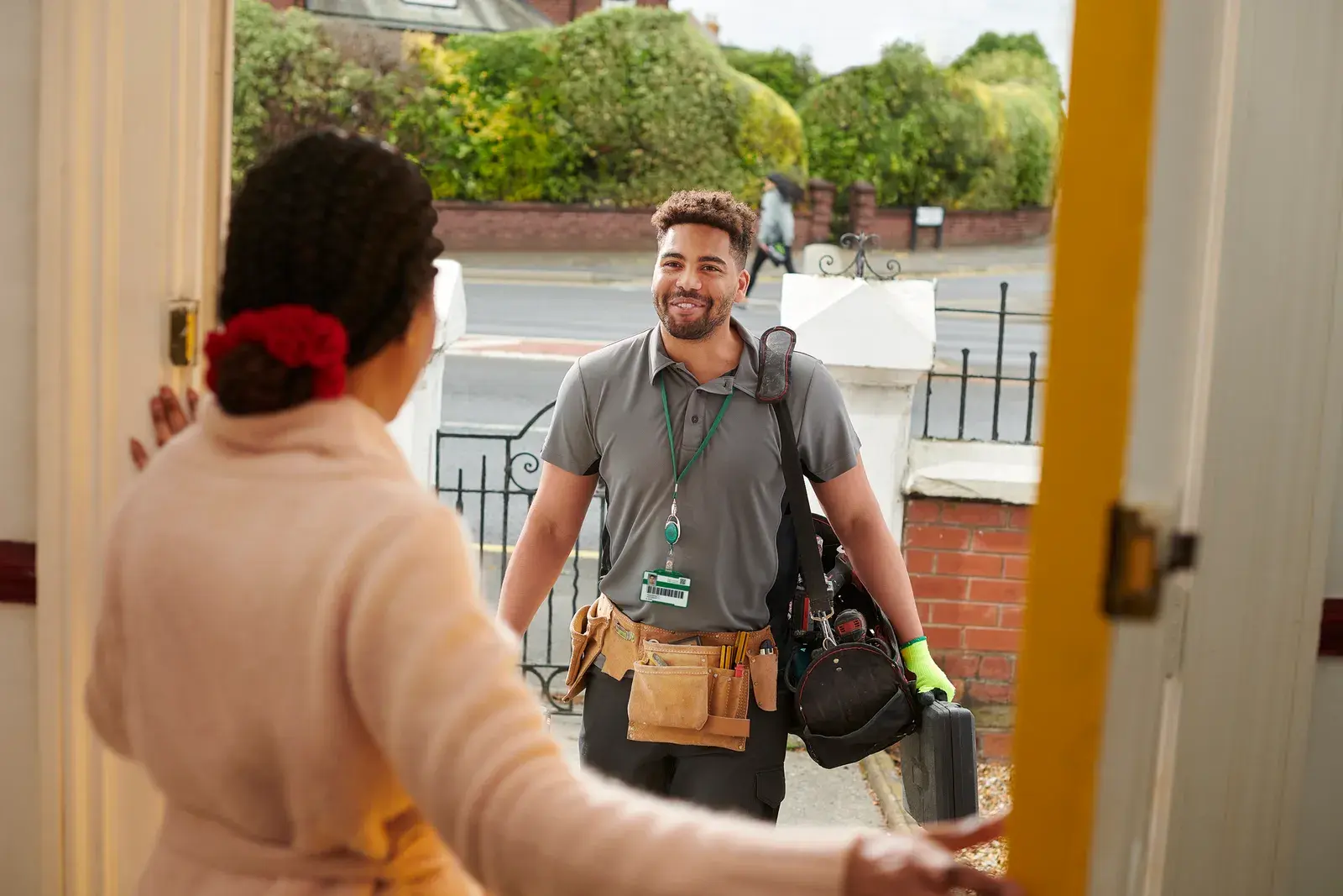 Home services technician greeting customer
