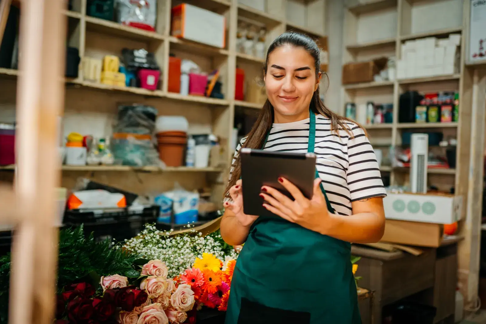 Small business owner using a tablet in her shop