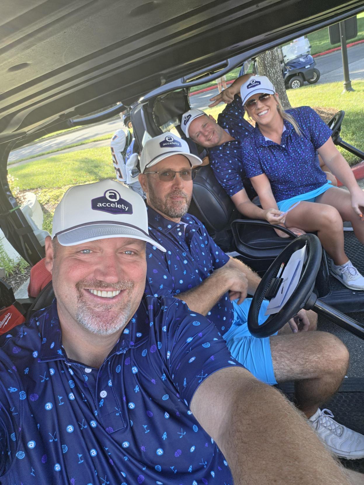Team selfie in a golf cart